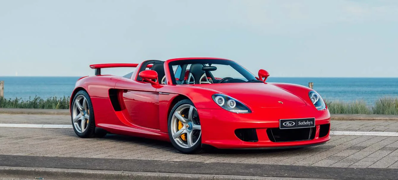 2005 Porsche Carrera GT in red beside the sea